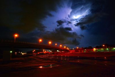 View of illuminated street lights at night