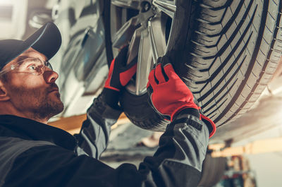 Close-up of mechanic working at garage