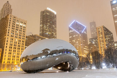 Modern buildings in city against sky during winter