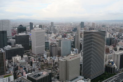 High angle view of modern buildings in city against sky