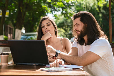 Young woman using laptop at table