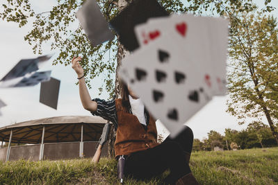 Low angle view of woman playing on field against sky