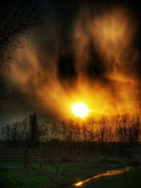 Scenic view of field against sky at sunset