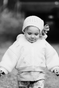 Portrait of cute girl standing in park during winter