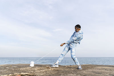 Man standing on beach against sky