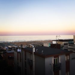 Scenic view of sea against clear sky at sunset