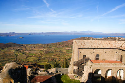 Panoramic view of old building by sea against sky