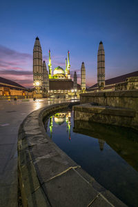 Reflection of illuminated buildings in city