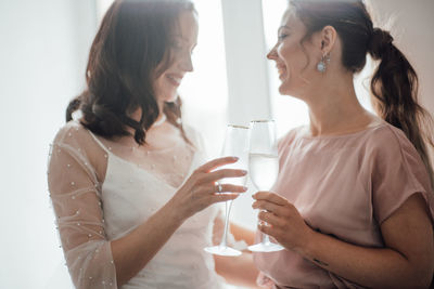 Young woman drinking water from glass