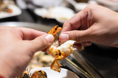 Close-up of hand holding ice cream