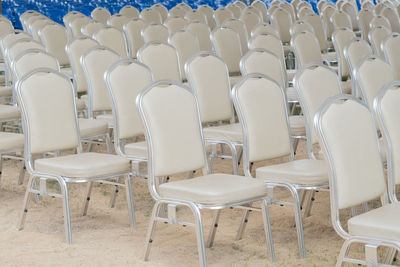 Empty chairs and tables in row