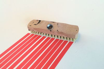 High angle view of striped pattern formed by scrubbing brush on white background