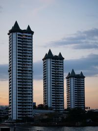 Low angle view of buildings against sky during sunset