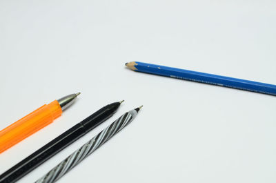 Close-up of colored pencils against white background