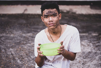 Portrait of man holding ice cream