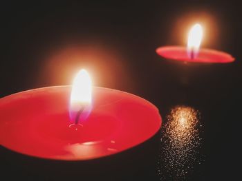 Close-up of lit candle in dark room