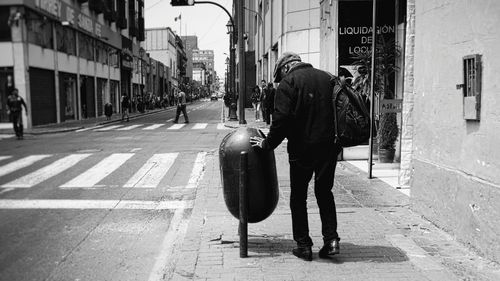 Rear view of man walking on road