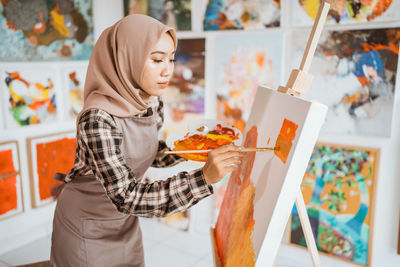 Portrait of young woman holding map