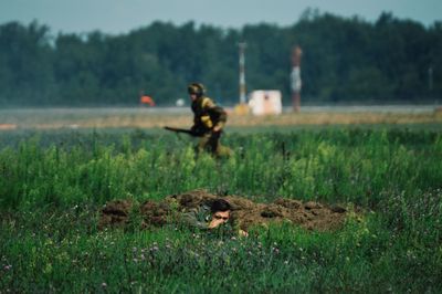 Full length of girl playing on grassy field