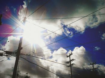 Low angle view of power lines against sky