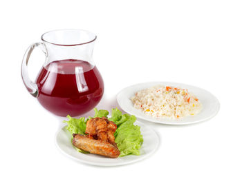 Close-up of food served in plate against white background