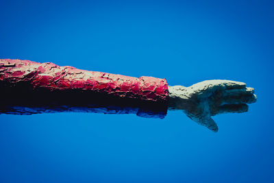 Low angle view of sculpture against blue sky