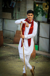 Portrait of young man standing in city