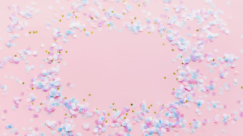 Digital composite image of pink flowers against sky