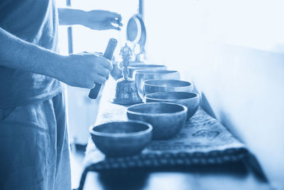 Midsection of man preparing food on table