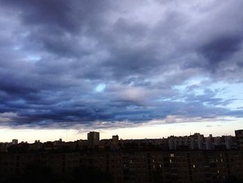 Cityscape against cloudy sky