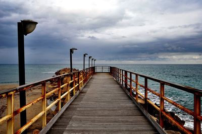 Pier over sea against sky