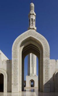 Low angle view of historical building against clear blue sky