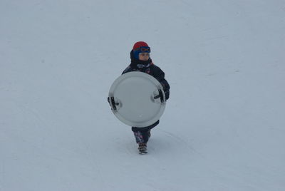 Full length of person on snowy field during winter