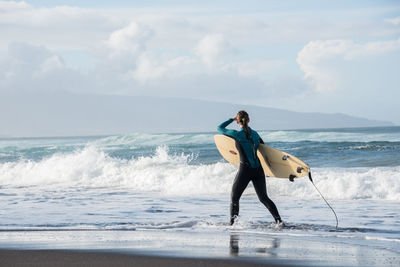 Full length of man on beach against sky