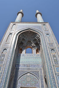 Low angle view of historical building against clear blue sky