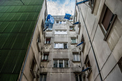 Low angle view of buildings in city against sky