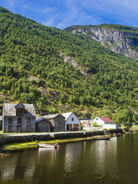 Houses at coast with motor boat moored in foreground