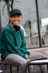 Portrait of a handsome man who looks happy. with a cool look using a hat and mask