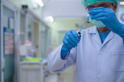 Midsection of person holding umbrella