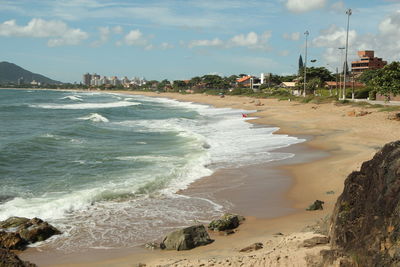 View of beach against cloudy sky