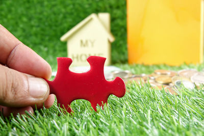 Close-up of hand holding red toy