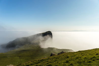 Scenic view of waterfall against sky