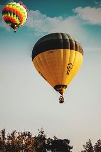 Low angle view of hot air balloons flying in sky