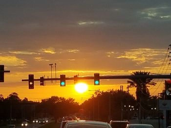 Cars on road at sunset