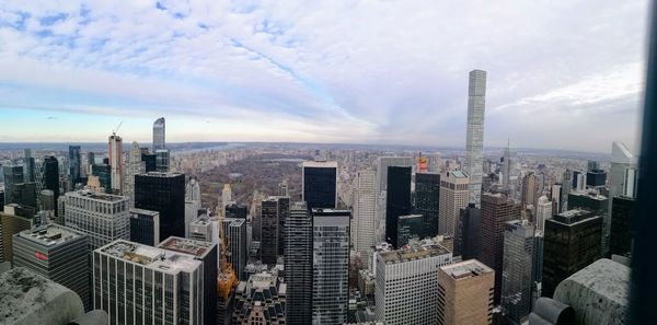 View of cityscape against cloudy sky