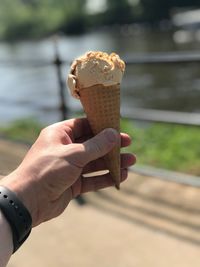 Close-up of hand holding ice cream cone