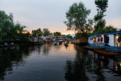 Boats moored in river against sky