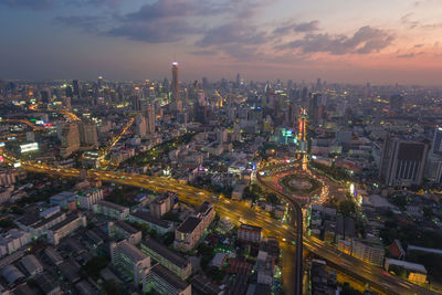 High angle view of illuminated city buildings against sky