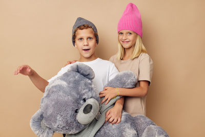 Portrait of smiling young woman with teddy bear