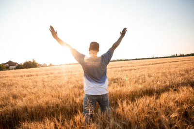 Full length of man standing on field against sky